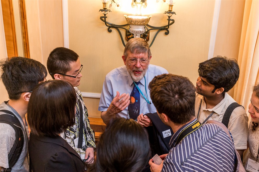 William Phillips discussion with young scientists during the poster session. 